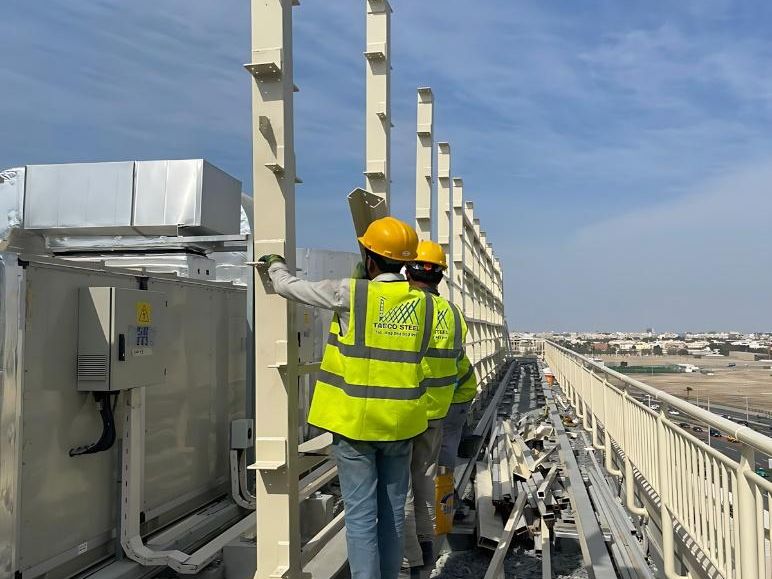 Technician working on a rooftop sign board steel structure