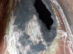 Corroded opening in the vessel wall before repair